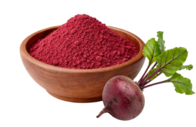 Beet powder in a wooden bowl next to a fresh beet with green leaves.